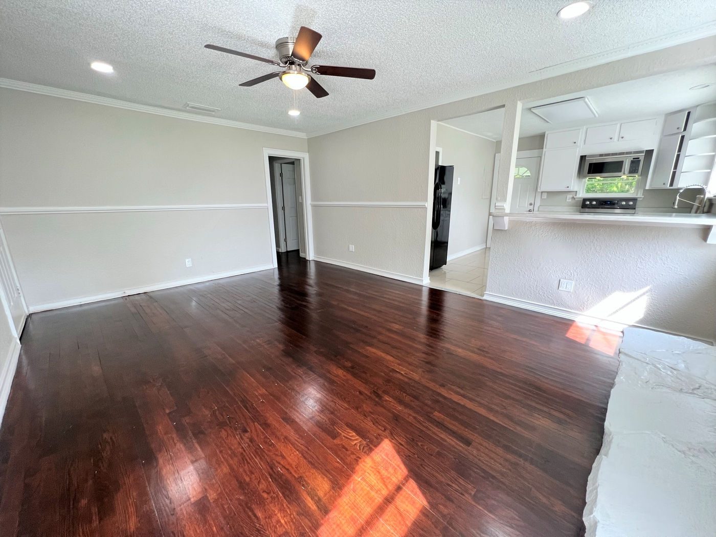 Room with dark wood floors at Homes at Oak Hill